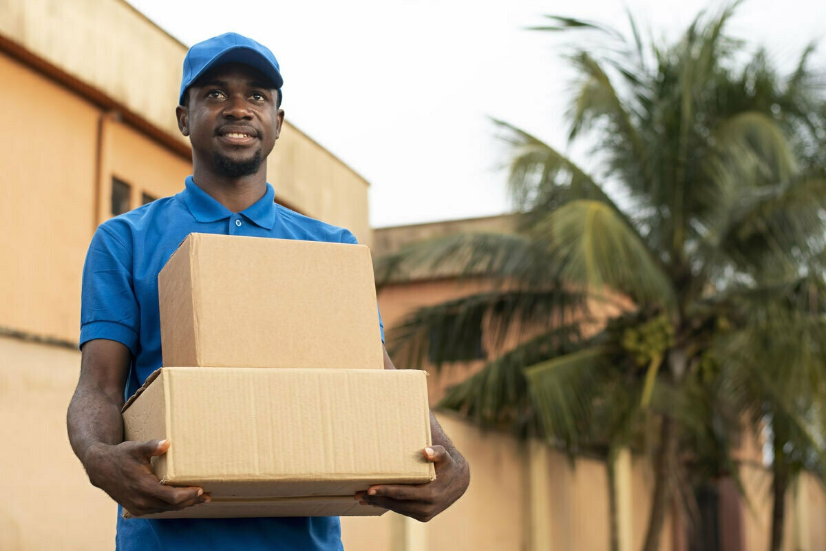 Close up of young black man holding boxes